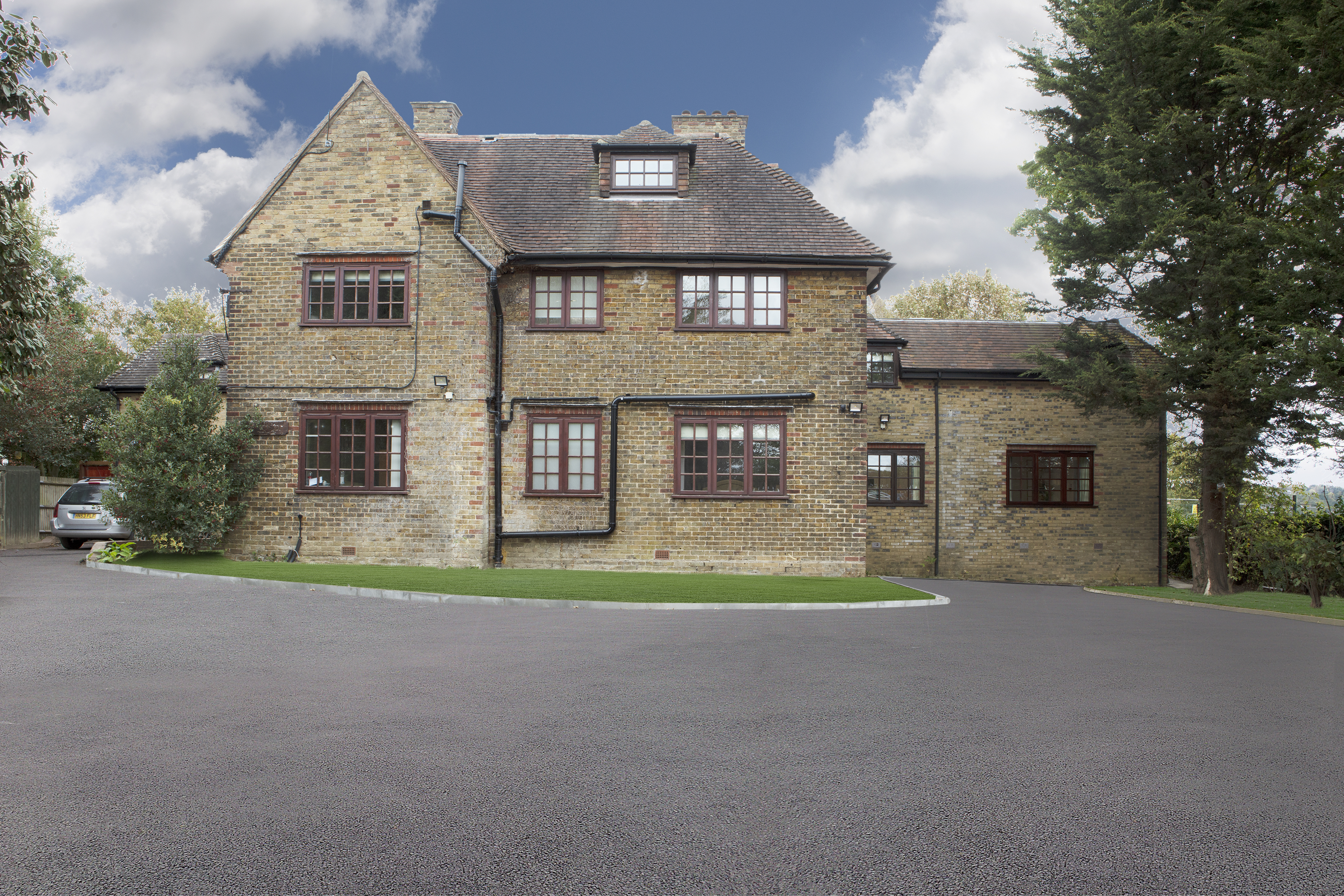 Image of the exterior of Eden House, a large brick building with driveway